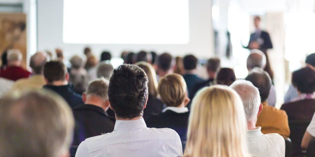 Group of people attending one of the best marketing conferences.