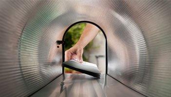 Image of putting mail into a mailbox