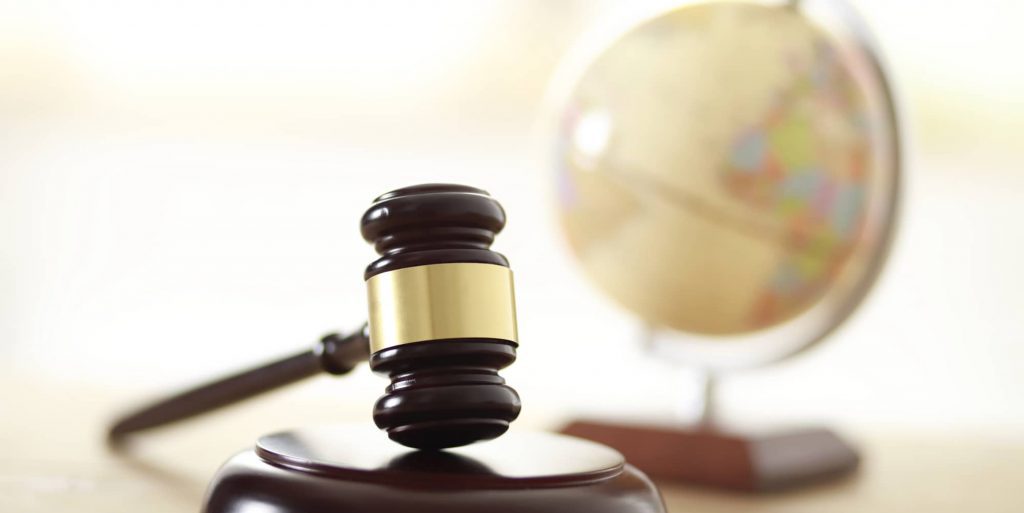 SMS marketing & GDPR compliance represented by a globe and gavel.