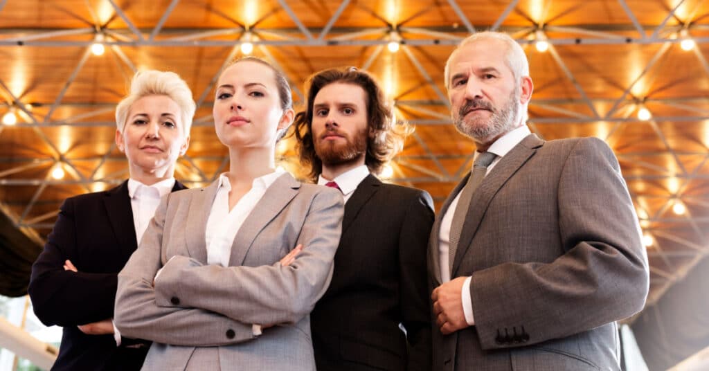 a group of intimidating business consultants threaten to ruin your tco when you implement marketing automation software