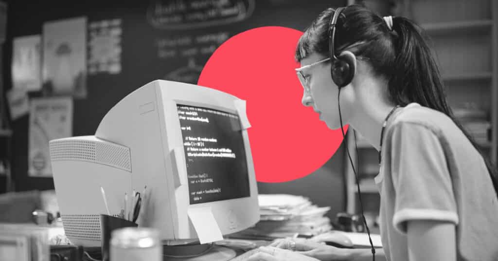 A woman operates an outdated computer wearing outdated headphones, time for her to implement new marketing automation