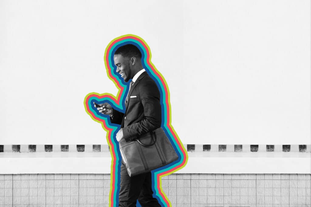 A man in business suit checks his phone to find sms marketing messages