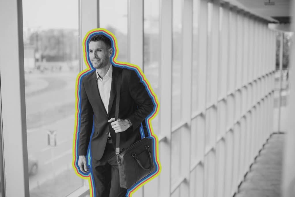 A man walks down a well lit corridor with a briefcase, illustrating the idea of sms marketing software