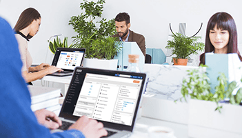 This picture is two women writing on a whiteboard. Choosing B2B marketing automation software requires a holistic view of brand, demand, and expand.