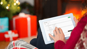 This is a picture of a woman wrapping a holiday present with a pull quote asking whether user engagement driving your holiday email strategy